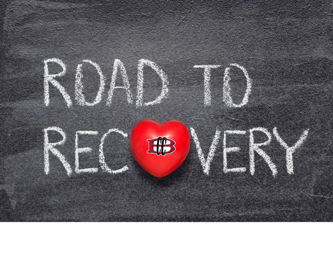 a black chalkboar with text Road to Recovery. The O in recovery is made of a heart with the bank logo on the center